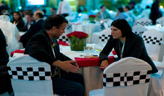 A photograph shows two people making eye contact during a conversation.